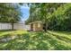View of backyard shed and the fence surrounding the property, surrounded by mature trees at 4816 N Fremont Ave, Tampa, FL 33603
