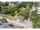Aerial view of the property showcasing its location near a pond and tree-lined streets at 551 Bay St, Dunedin, FL 34698
