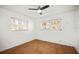 Bedroom featuring hardwood floors, modern ceiling fan, and natural light from two windows at 551 Bay St, Dunedin, FL 34698