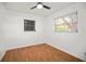Second bedroom with hardwood floors, white walls, and natural light from two windows at 551 Bay St, Dunedin, FL 34698