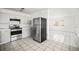 Kitchen with light gray cabinets, tile backsplash, stainless steel appliances and tile floors at 551 Bay St, Dunedin, FL 34698