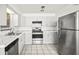 Bright kitchen features updated appliances, tile floors and white subway tile backsplash at 551 Bay St, Dunedin, FL 34698