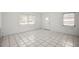 Bright living area with tiled floors, white walls, and natural light from large windows at 551 Bay St, Dunedin, FL 34698