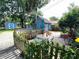 Charming backyard featuring a delightful shed, a lush garden, and an inviting outdoor seating area at 5812 Montana Ave, New Port Richey, FL 34652