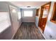 Sunlit entryway featuring tiled floors, a window, and white door at 5812 Montana Ave, New Port Richey, FL 34652