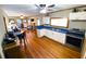 Bright and open kitchen featuring white cabinets, stainless steel appliances, and wood floors at 5812 Montana Ave, New Port Richey, FL 34652