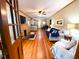 Inviting living room boasting hardwood floors, brick fireplace, and ample natural light at 5812 Montana Ave, New Port Richey, FL 34652