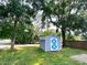 This property includes a shed that features white trim and blue painted cross bucks at 5812 Montana Ave, New Port Richey, FL 34652