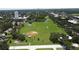 Expansive green field with baseball diamond, playground, and scenic pond offers recreation and nature in a vibrant community setting at 6045 2Nd N Ave, St Petersburg, FL 33710
