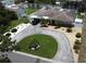 Aerial view of home featuring circular driveway, lush landscaping, and fenced backyard, showcasing its curb appeal at 6045 2Nd N Ave, St Petersburg, FL 33710