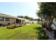 Expansive backyard featuring a covered patio, lush green lawn, and beautifully landscaped garden beds at 6045 2Nd N Ave, St Petersburg, FL 33710