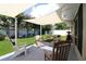 Backyard patio featuring several chairs, a shade sail, and a well-manicured lawn at 6045 2Nd N Ave, St Petersburg, FL 33710
