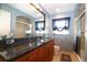 Bathroom with a glass shower, wood cabinets, and a beautiful mirror at 6045 2Nd N Ave, St Petersburg, FL 33710