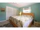 Comfortable bedroom with light blue walls, a double bed, and a closet at 6045 2Nd N Ave, St Petersburg, FL 33710