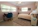Cozy bedroom with pink walls, a single bed, a desk, and two windows at 6045 2Nd N Ave, St Petersburg, FL 33710