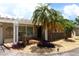 Charming home with a pergola-covered front entrance, palm trees, and well-maintained landscaping at 6045 2Nd N Ave, St Petersburg, FL 33710