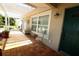 Welcoming front porch with tiled flooring, seating, and a view of the landscaped yard at 6045 2Nd N Ave, St Petersburg, FL 33710