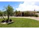 Well-manicured front yard with lush green grass, mature palm trees, and a circular driveway at 6045 2Nd N Ave, St Petersburg, FL 33710