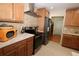 Kitchen with light wood cabinets, stainless appliances, and a brick-style backsplash at 6045 2Nd N Ave, St Petersburg, FL 33710