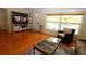 Cozy living room features hardwood floors, a large window, and comfortable seating at 6045 2Nd N Ave, St Petersburg, FL 33710