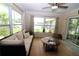 Cozy living room with a comfortable sofa, large windows, and a view of the backyard at 6045 2Nd N Ave, St Petersburg, FL 33710