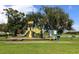 A colorful playground featuring a slide and play structures, perfect for Gathering recreation in a park setting at 6045 2Nd N Ave, St Petersburg, FL 33710