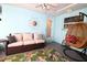Comfortable sunroom featuring a comfortable sofa, a hanging chair, and tropical decor at 6045 2Nd N Ave, St Petersburg, FL 33710