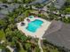 Aerial view featuring neighborhood pool, clubhouse, playground and green spaces in a residential neighborhood at 6519 Watson Rd, Riverview, FL 33578