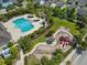 Aerial view showcases a community pool, playground, and green spaces in a residential neighborhood at 6519 Watson Rd, Riverview, FL 33578