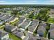 Aerial view showcasing a residential neighborhood with well-maintained homes and tree-lined streets at 6519 Watson Rd, Riverview, FL 33578
