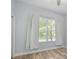 Bright, empty bedroom featuring beautiful natural light and hardwood floors at 6519 Watson Rd, Riverview, FL 33578