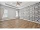Spacious bedroom with floral accent wall, recessed lighting, and natural light at 6519 Watson Rd, Riverview, FL 33578