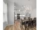 Open concept dining area with view into modern kitchen and light-colored floors at 6519 Watson Rd, Riverview, FL 33578
