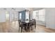 Open concept dining room with light-colored floors and an elegant hanging light fixture at 6519 Watson Rd, Riverview, FL 33578