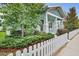 Charming home exterior with a white picket fence, lush landscaping, and a covered front porch at 6519 Watson Rd, Riverview, FL 33578