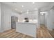 Modern kitchen with white cabinets, stainless steel appliances, and a center island at 6519 Watson Rd, Riverview, FL 33578
