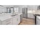 Modern kitchen features white cabinets, stainless steel appliances, and a light-colored countertop at 6519 Watson Rd, Riverview, FL 33578