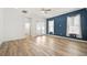Bright and airy living room with an accent wall and light-colored wood-look flooring at 6519 Watson Rd, Riverview, FL 33578