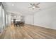Open floorplan featuring living and dining areas with hardwood floors, and an adjacent modern kitchen at 6519 Watson Rd, Riverview, FL 33578