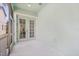 Screened-in porch with neutral concrete floors and glass panel doors that open up to the house interior at 6519 Watson Rd, Riverview, FL 33578