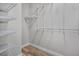 Walk-in closet with customizable shelving and light-colored wood-look flooring at 6519 Watson Rd, Riverview, FL 33578