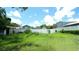 View of a backyard with an overgrown lawn at 708 E Annie St, Tampa, FL 33612