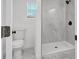 Modern bathroom with marble tile shower and updated toilet at 708 E Annie St, Tampa, FL 33612