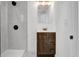 Bathroom featuring marble tile shower and dark wood vanity at 708 E Annie St, Tampa, FL 33612
