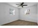 Bedroom with large windows offering ample natural light and wood-look flooring at 708 E Annie St, Tampa, FL 33612