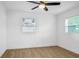 Bedroom with light-colored wood-look floors and two windows at 708 E Annie St, Tampa, FL 33612