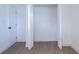 Bedroom closet with bifold doors and wood-look floor at 708 E Annie St, Tampa, FL 33612