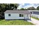 Exterior view of a cozy home, featuring a new roof and freshly painted siding at 708 E Annie St, Tampa, FL 33612