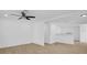 Spacious living room with modern ceiling fan and light wood-look floors at 708 E Annie St, Tampa, FL 33612