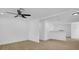 Spacious living room featuring modern ceiling fan and light wood-look floors at 708 E Annie St, Tampa, FL 33612
